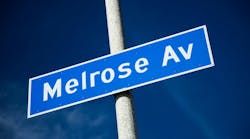 Outdoor daylight photo of Melrose Ave. sign with blue sky in Los Angeles. Photo: billnol via iStock