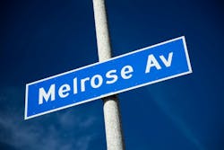 Outdoor daylight photo of Melrose Ave. sign with blue sky in Los Angeles. Photo: billnol via iStock
