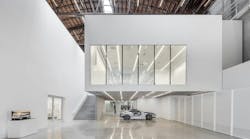 This image from the Fabrication Lab on level one features a “cut away” Jaguar F-Type and shows the hovering flexible lecture / gallery space above. Photo: Joshua White