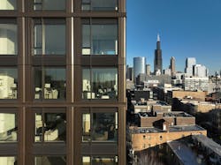 large window openings offer framed views of the surrounding cityscape