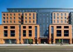 Chapter Madison Exterior: At Chapter Madison, an LJC-designed student housing complex at 832 Regent St. near the University of Wisconsin-Madison, dark metal cladding breaks up masonry massing to create a visual effect evocative of the area’s historic rowhomes