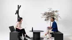 Two people sitting on outdoor furniture in front of white background