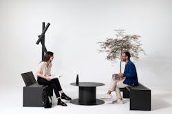 Two people sitting on outdoor furniture in front of white background
